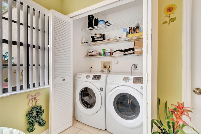 laundry room with separate washer and dryer and light tile patterned flooring