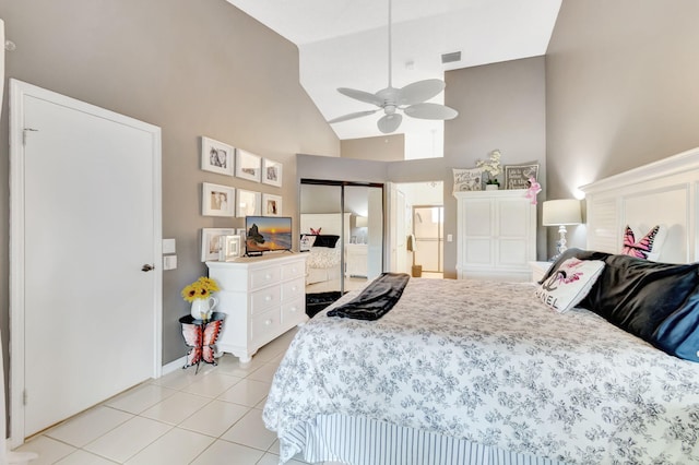 tiled bedroom with high vaulted ceiling, a closet, and ceiling fan