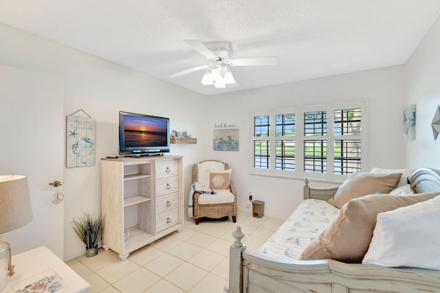 living room with ceiling fan, a textured ceiling, and light tile patterned floors