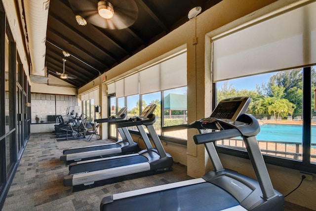 exercise room featuring vaulted ceiling and ceiling fan