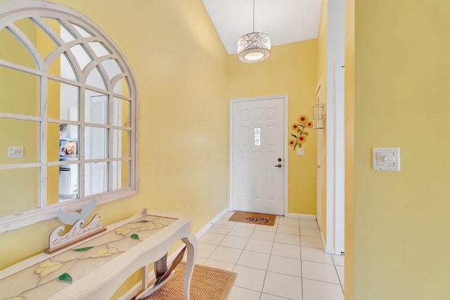 tiled foyer entrance featuring vaulted ceiling