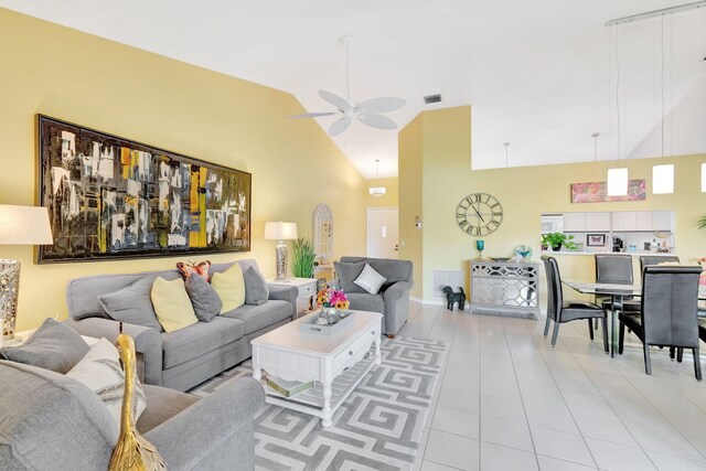 tiled living room featuring high vaulted ceiling and ceiling fan