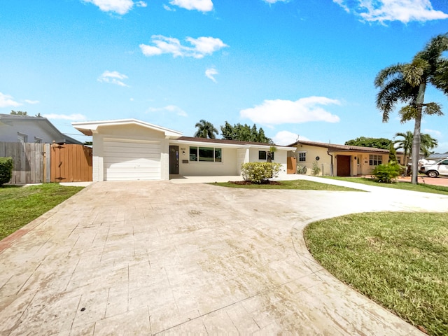 single story home with a garage and a front lawn