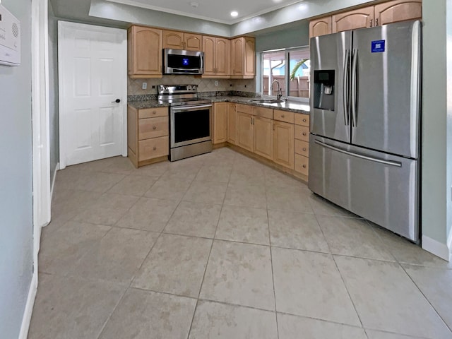 kitchen featuring light tile patterned floors, ornamental molding, stainless steel appliances, and sink