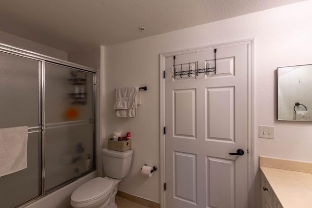 full bathroom with a textured ceiling, bath / shower combo with glass door, vanity, and toilet