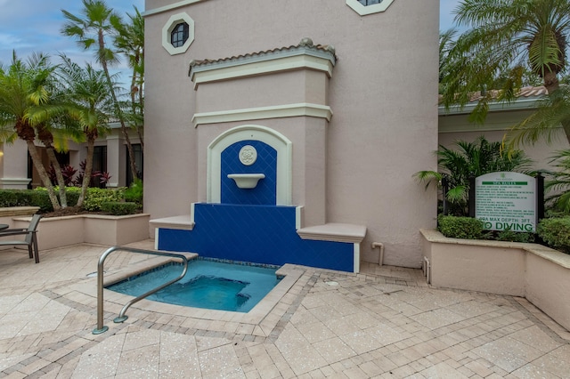 view of pool with a patio area and a hot tub