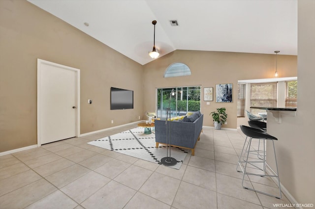 living room featuring light tile patterned floors and high vaulted ceiling