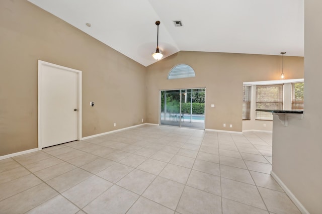 unfurnished living room with light tile patterned floors and high vaulted ceiling