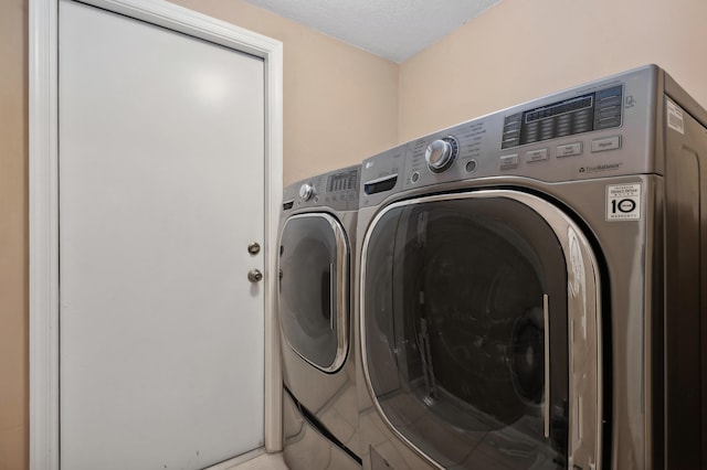 clothes washing area with separate washer and dryer