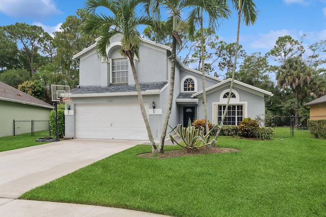 view of front of property with a garage and a front lawn