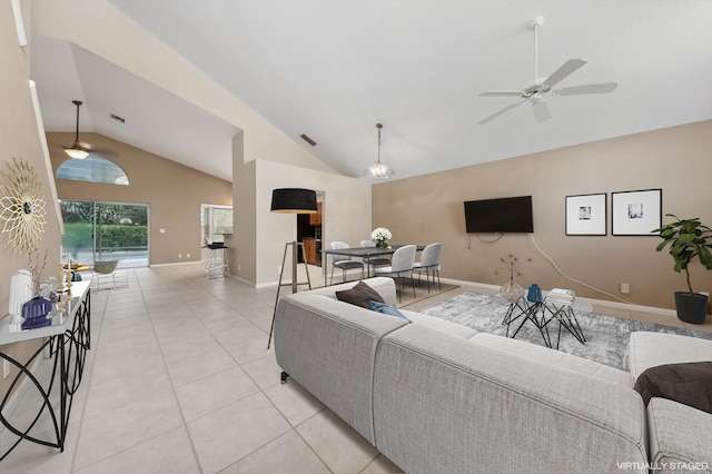 tiled living room featuring ceiling fan and vaulted ceiling