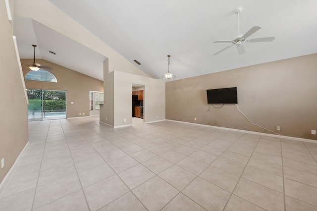 tiled empty room featuring ceiling fan with notable chandelier and high vaulted ceiling