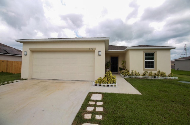 view of front of home with a front lawn and a garage