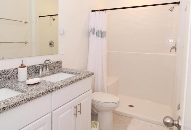 bathroom with toilet, vanity, a shower with shower curtain, and tile patterned floors