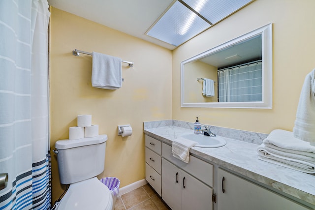 bathroom featuring tile patterned flooring, vanity, and toilet