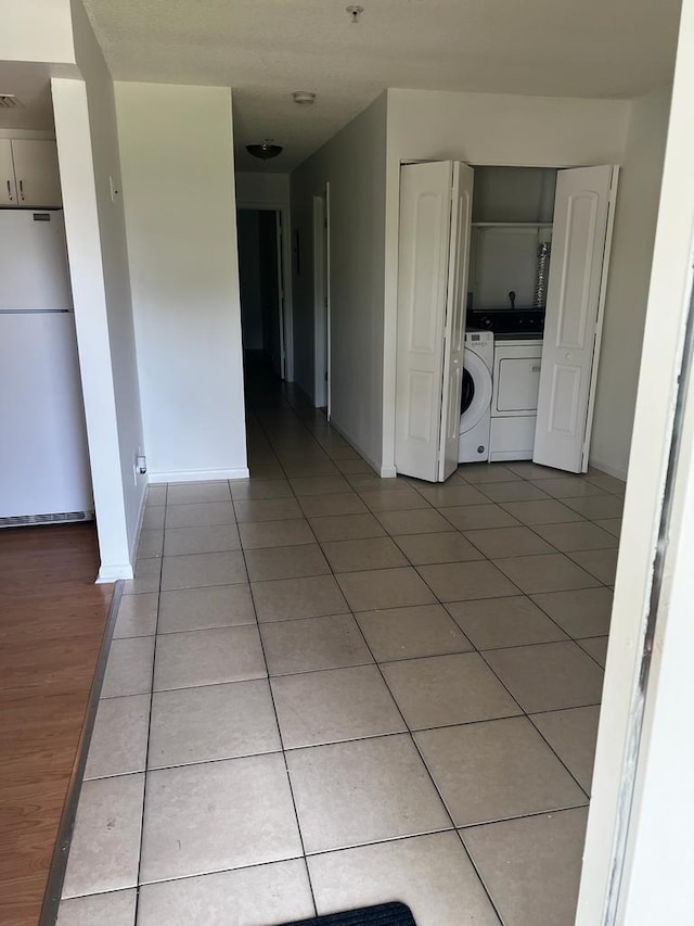 interior space featuring wood-type flooring and separate washer and dryer