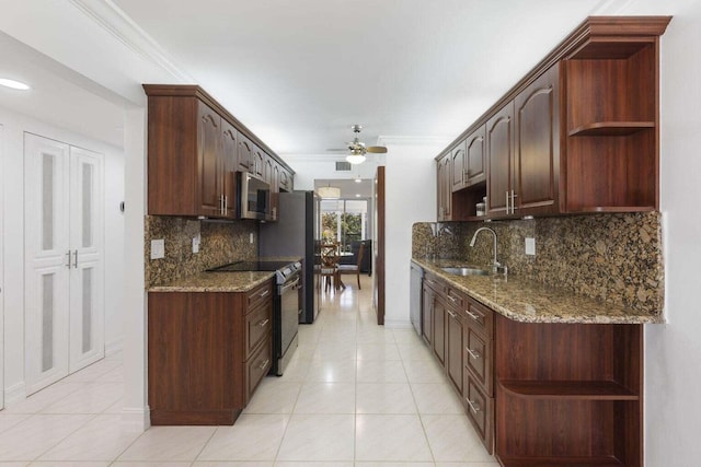 kitchen with ceiling fan, sink, dark brown cabinets, appliances with stainless steel finishes, and dark stone counters