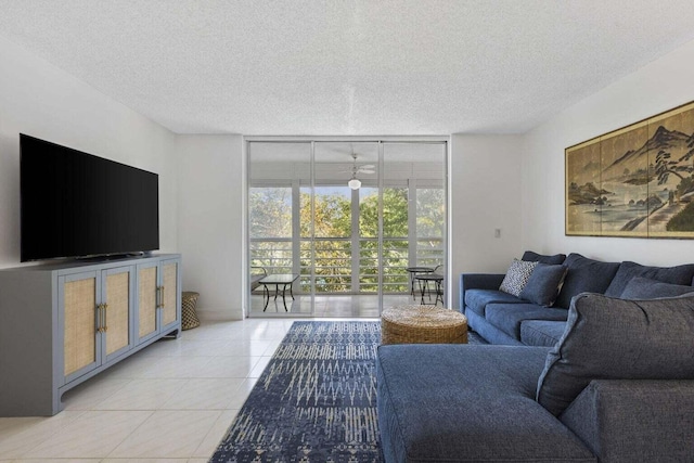 living room with floor to ceiling windows, a textured ceiling, and light tile patterned floors