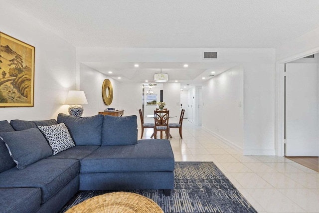 tiled living room with a textured ceiling