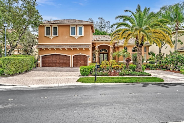 mediterranean / spanish house with a garage