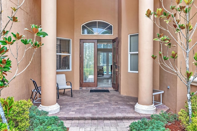 view of exterior entry with a patio