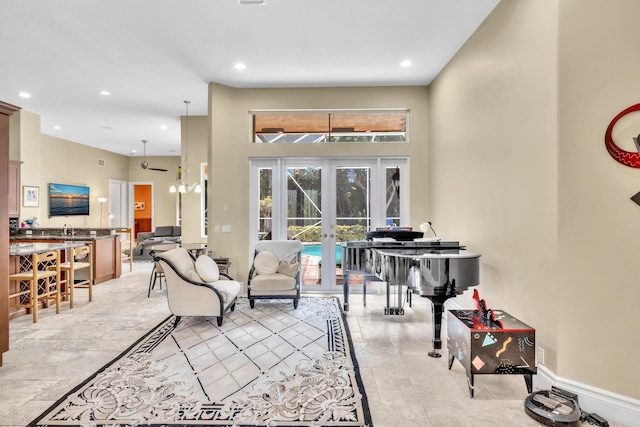 living room featuring ceiling fan and french doors