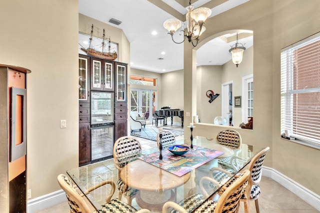 dining space with plenty of natural light, french doors, and a chandelier