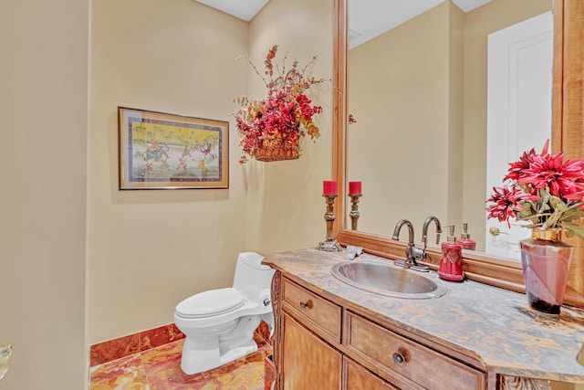 bathroom featuring tile patterned flooring, vanity, and toilet