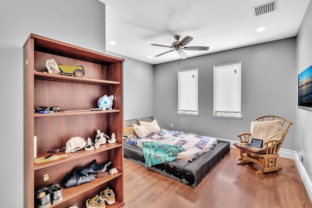 bedroom featuring light wood-type flooring and ceiling fan