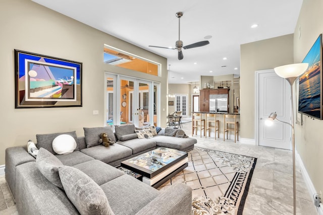 living room featuring ceiling fan and french doors