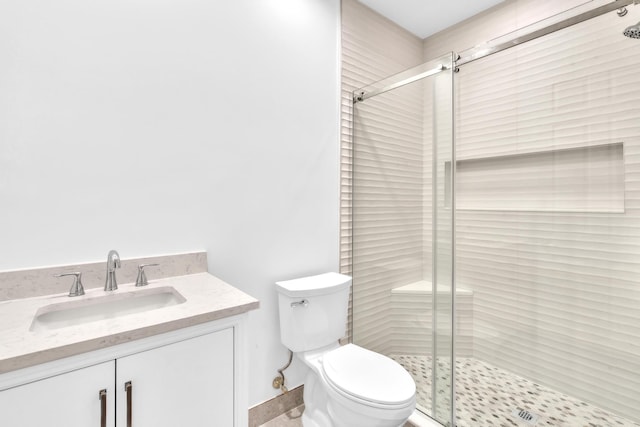 bathroom featuring an enclosed shower, vanity, and toilet