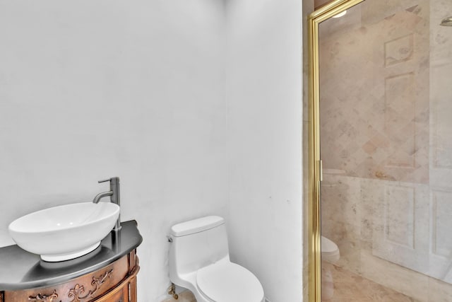 bathroom featuring vanity, an enclosed shower, and toilet