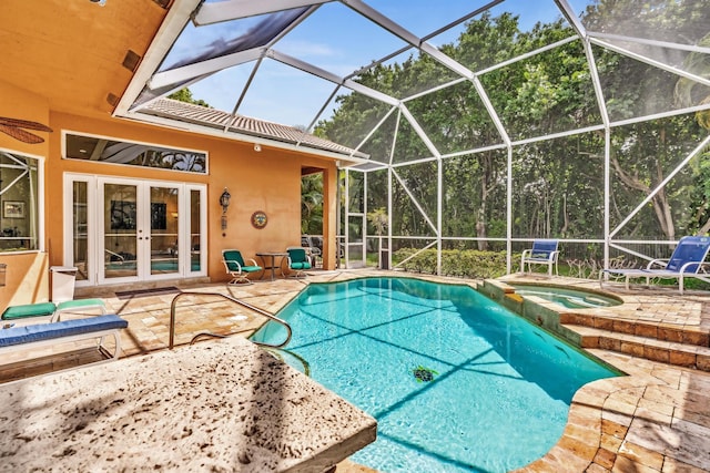 view of swimming pool featuring an in ground hot tub, french doors, a patio, and a lanai