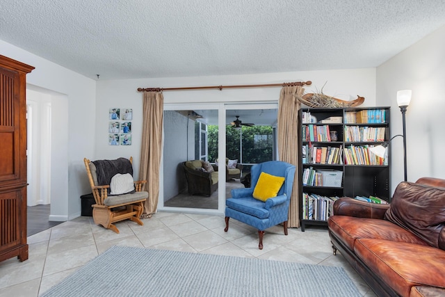 sitting room with light tile patterned floors and a textured ceiling