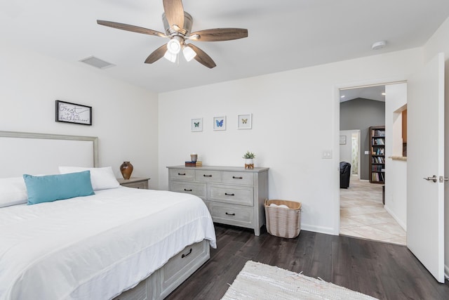 bedroom featuring ceiling fan, dark wood-type flooring, and lofted ceiling