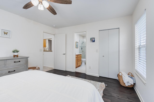 bedroom featuring ceiling fan, ensuite bathroom, dark wood-type flooring, and a closet