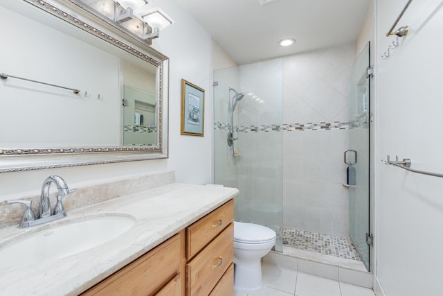 bathroom with tile patterned flooring, vanity, toilet, and an enclosed shower