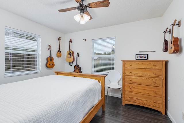 bedroom with ceiling fan and dark hardwood / wood-style floors