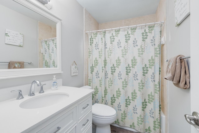 bathroom with hardwood / wood-style flooring, vanity, and toilet