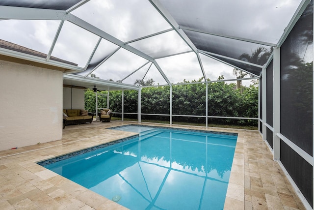 view of pool with a patio area, ceiling fan, glass enclosure, and an outdoor hangout area