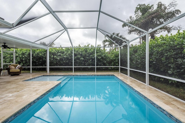 view of swimming pool with a lanai and a patio area