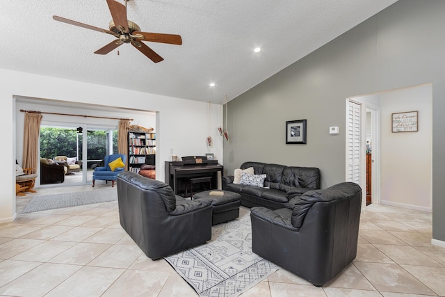 tiled living room featuring ceiling fan, high vaulted ceiling, and a textured ceiling