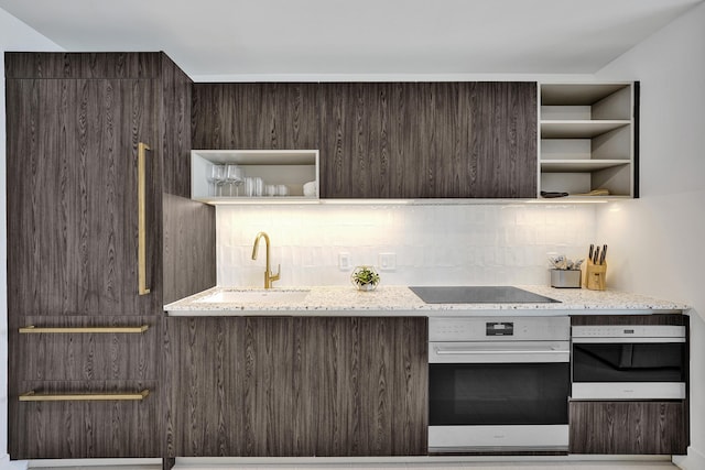 601 NE 1st Ave Unit 4813, Miami, FL 33132 - kitchen featuring oven, open shelves, black electric stovetop, and dark brown cabinets
