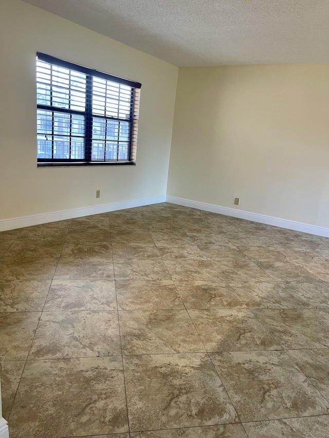 empty room with a textured ceiling