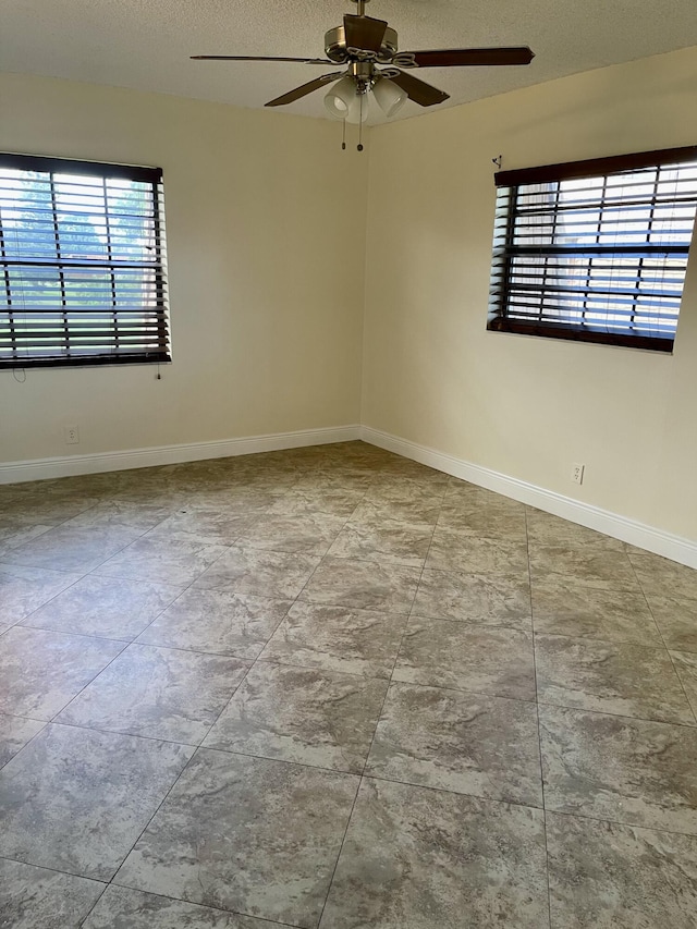 unfurnished room featuring a textured ceiling and ceiling fan