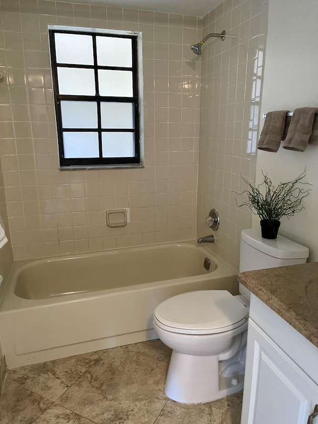 full bathroom featuring vanity, tiled shower / bath combo, toilet, and tile patterned floors