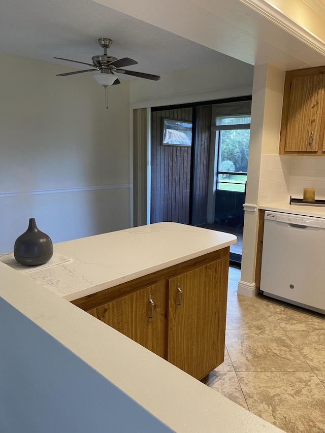 kitchen featuring ceiling fan, white dishwasher, and tasteful backsplash