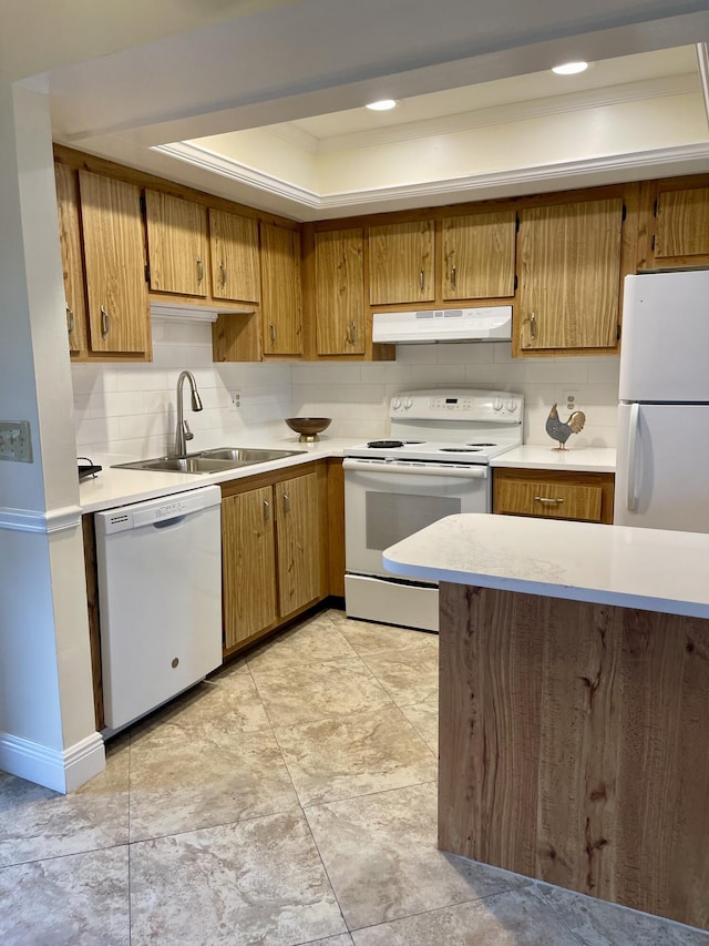 kitchen featuring backsplash, white appliances, crown molding, and sink