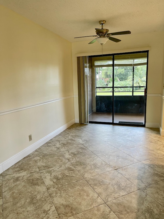 spare room with a textured ceiling and ceiling fan