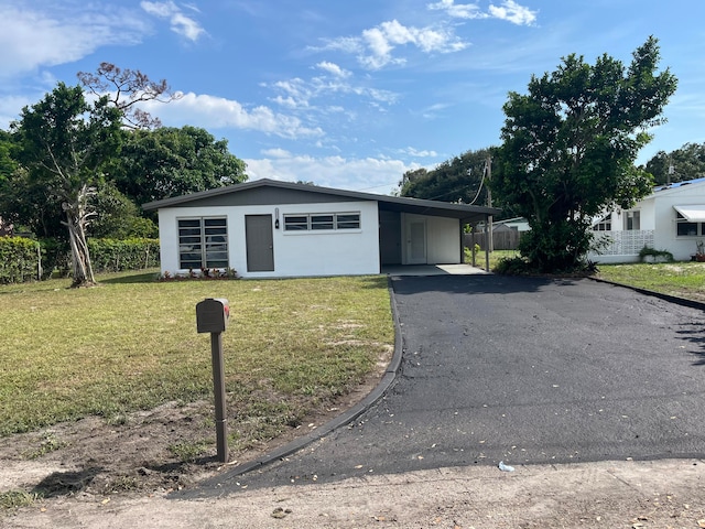 single story home featuring a front yard and a carport